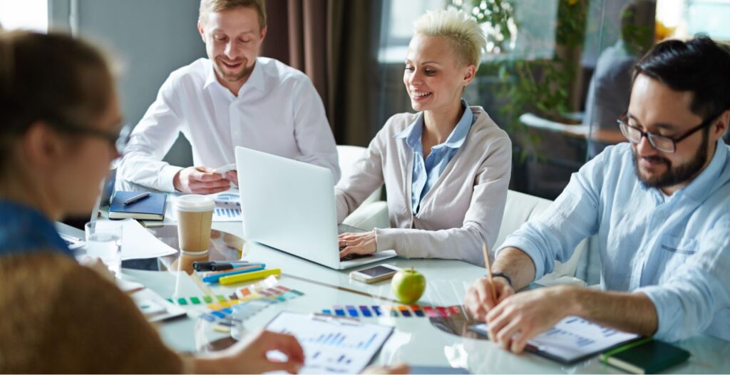 Young business people working at conference table as a group.