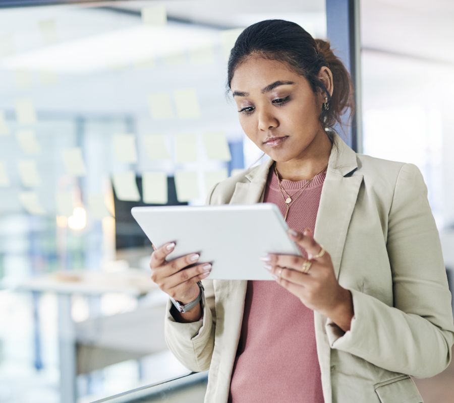 Stock image of a woman holding a tablet.