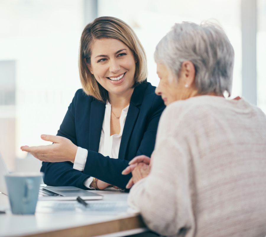 Stock image of younger and older woman talking.